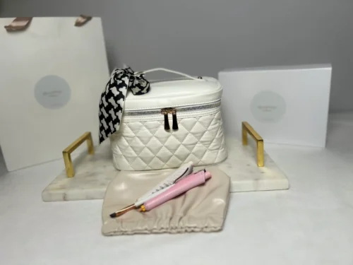 White quilted cosmetic case with tools.