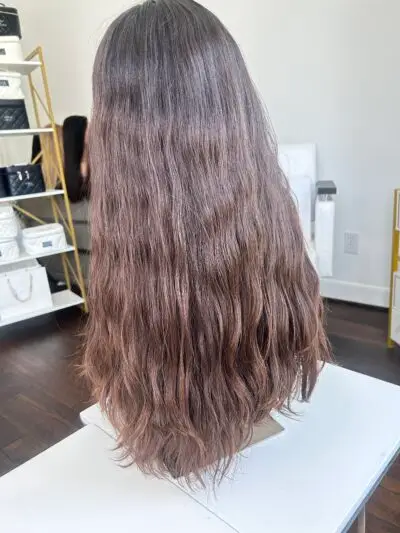 Woman wearing stylish curly blonde wig.