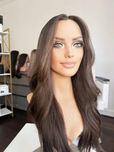 Woman wearing stylish long curly wig.