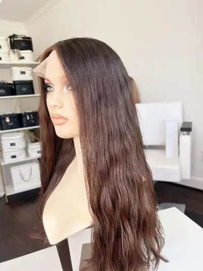 Woman wearing a stylish curly brown wig.