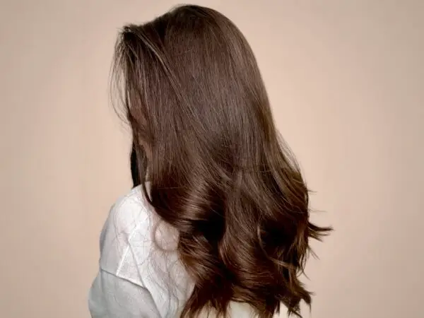 Woman with long, wavy brown hair.
