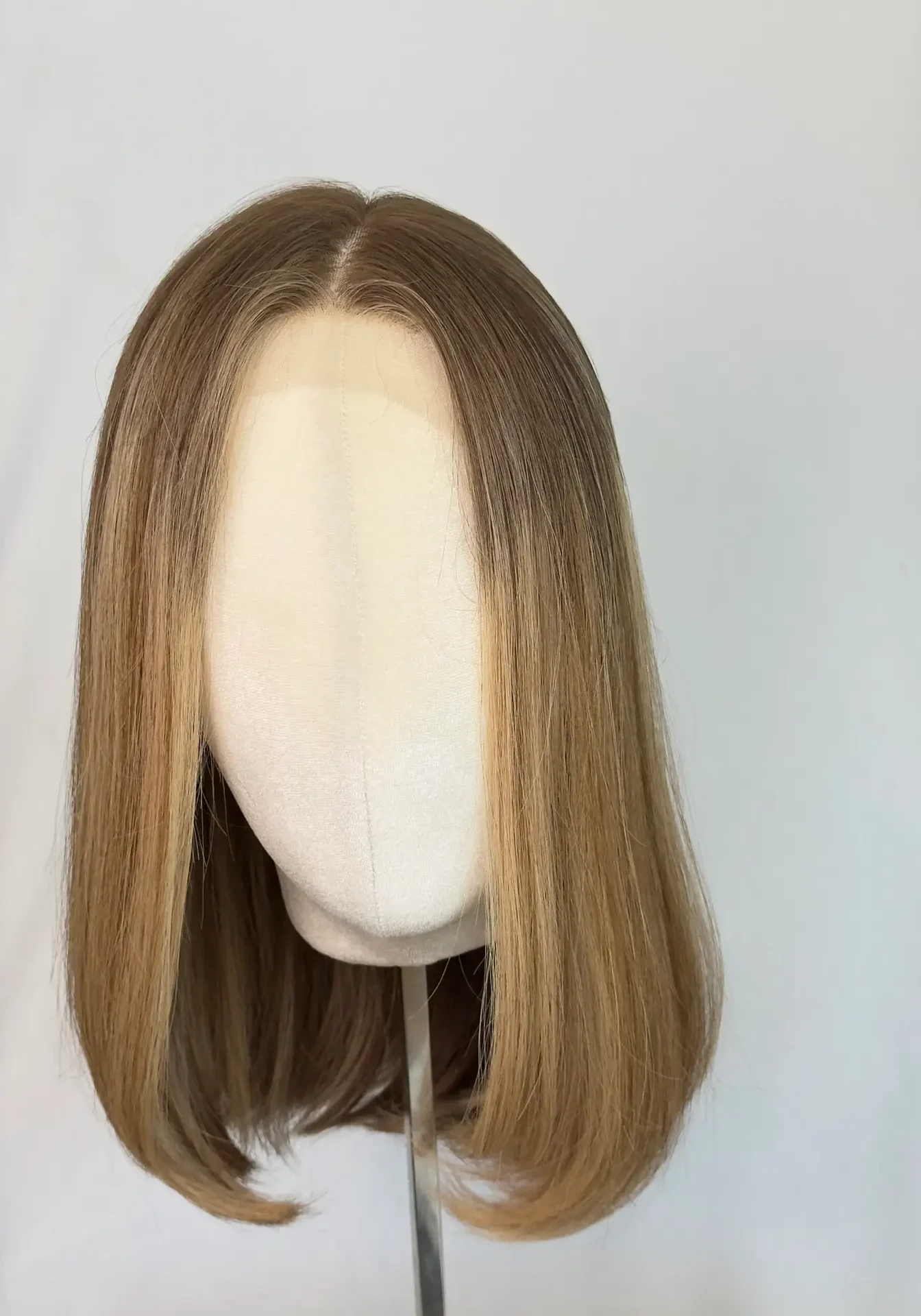Mid-length straight brown wig on mannequin