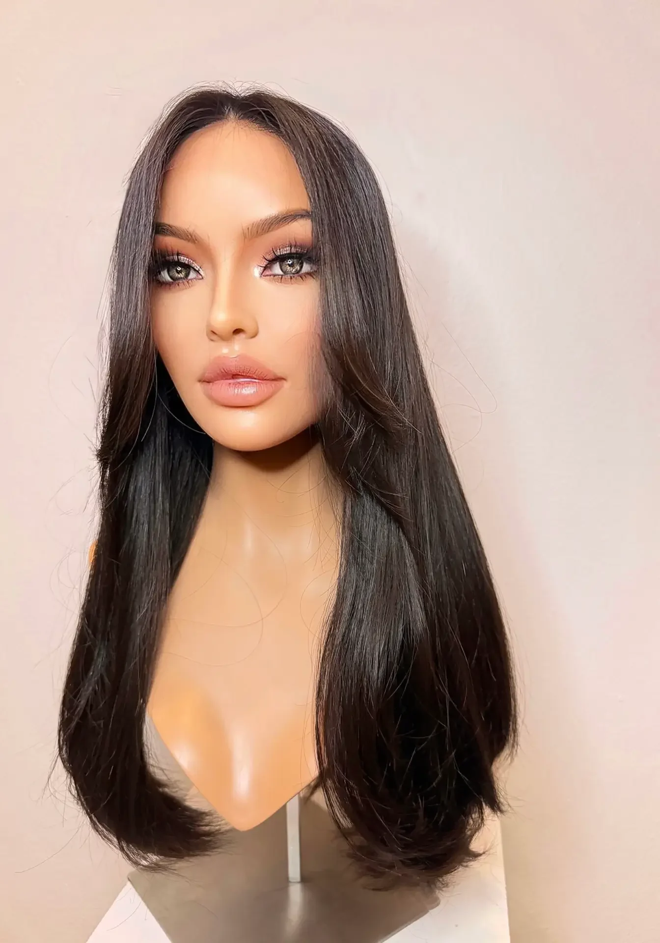 Brunette mannequin head with long straight hair.