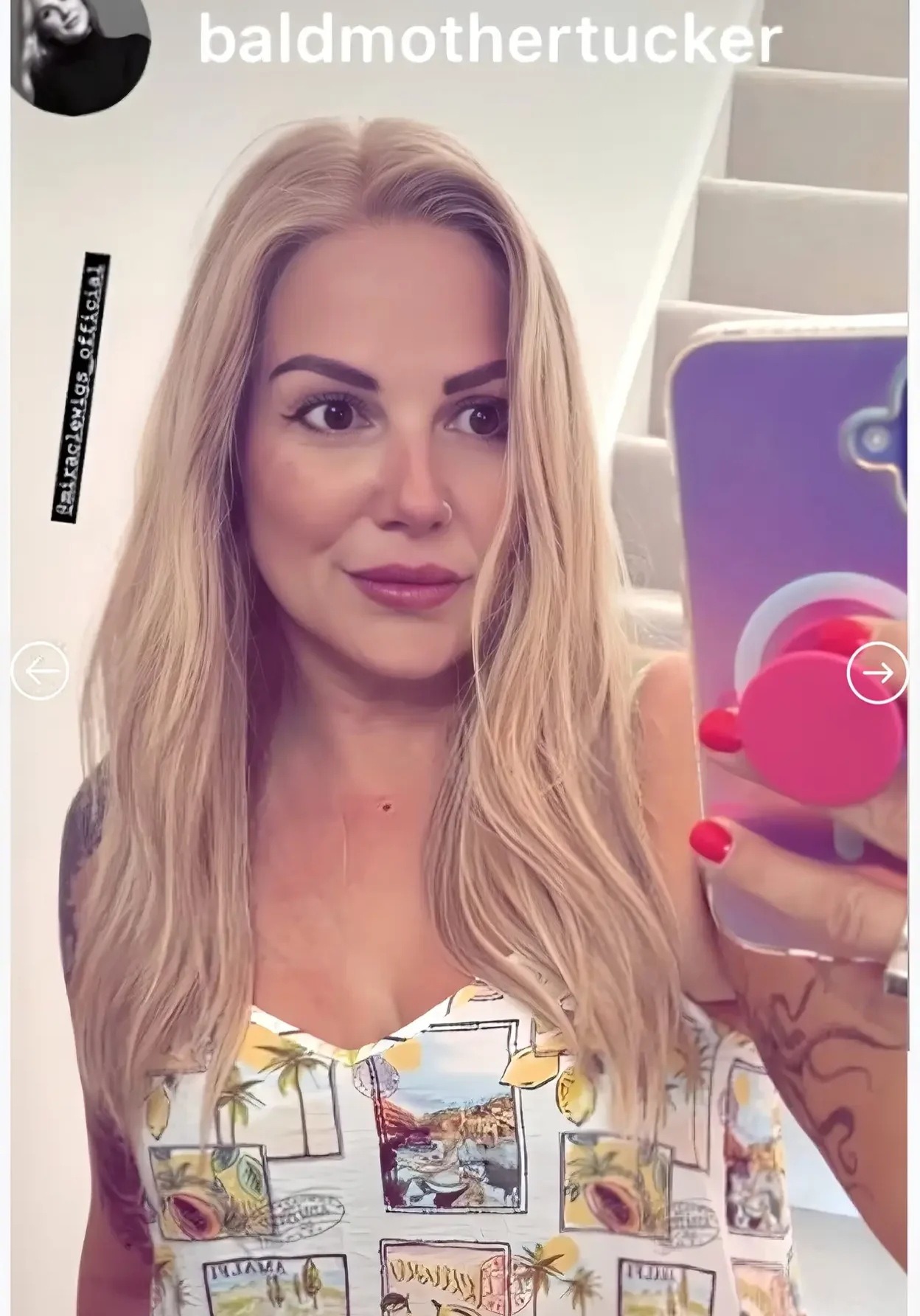 Woman taking a selfie in colorful top.