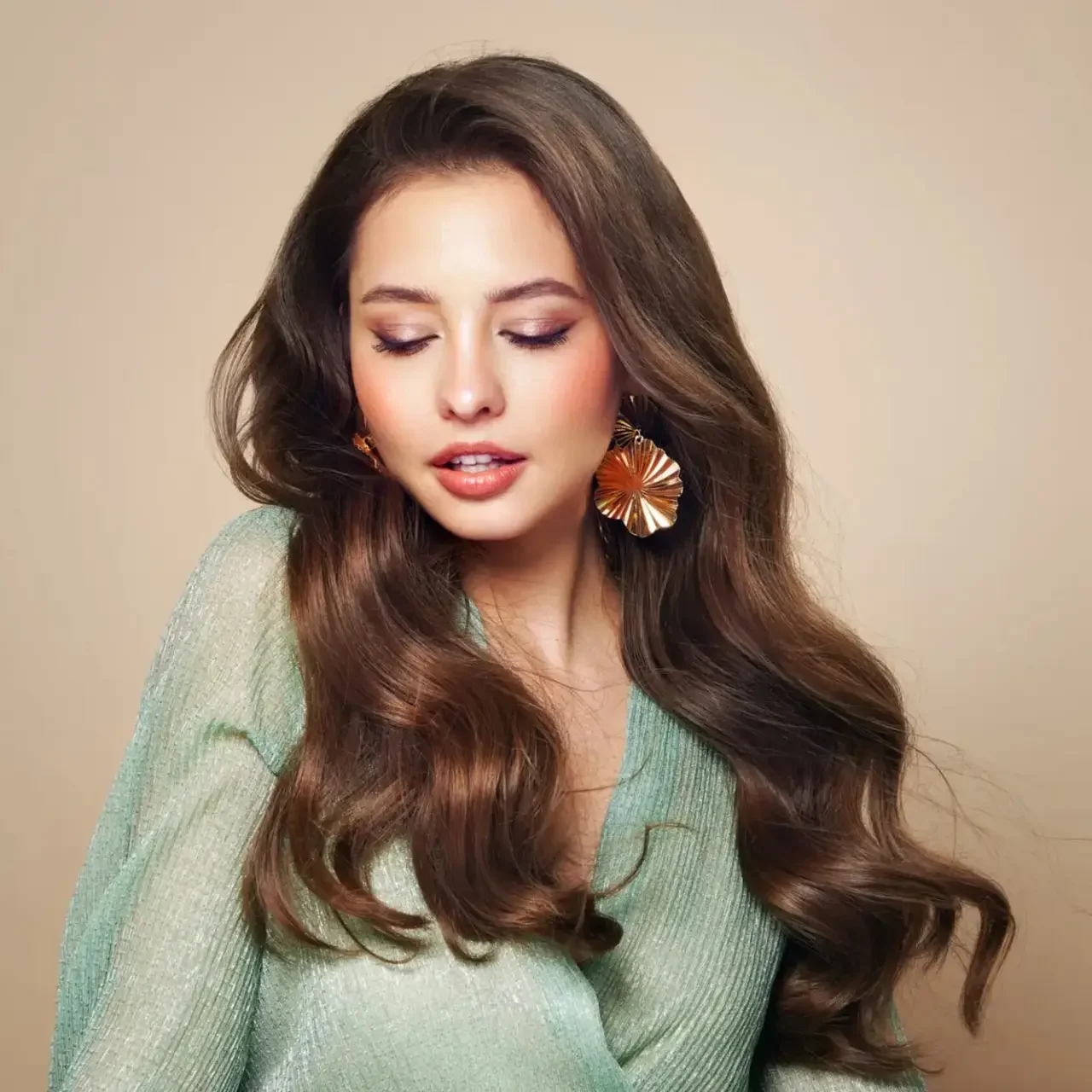 Woman with long hair and large earrings.
